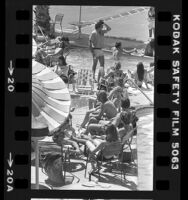 People mingling around pool during Spring Break in Palm Springs, Calif., 1980