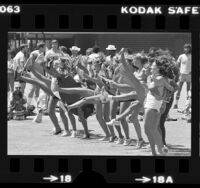 Los Angeles Rams cheerleader candidates performing a kickline, 1980