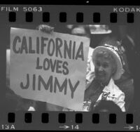 Woman delegate wearing a campaign hat and holding sign reading "California Loves Jimmy" at the 1980 Democratic National Convention in New York