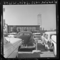 Automobiles crowd parking lot of Garden Grove Community Church for indoor/outdoor service, Calif., 1961