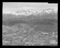 Pasadena Freeway and grading work on Chavez Ravine with backdrop of San Gabriel Mountains, Los Angeles, 1962