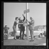 Los Angeles police demonstrating solar powered emergency call box on Santa Monica Freeway, 1962