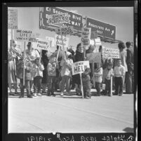 Pickets in Westchester area staging protest at opening of new freeway link in Los Angeles, Calif., 1963