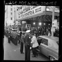 Movie fans, reporters and valets at entrance of Pantages Theater during benefit premiere of motion picture "Cleopatra" in Hollywood, Calif., 1963