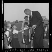Vice President Lyndon Johnson shaking hands with members of Happy Bluebirds troop upon his arrival at LAX, 1963