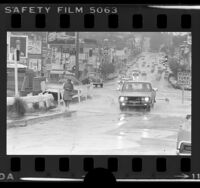 Street scene during rain storm on Sunset Blvd. and Reservoir St. in Los Angeles, Calif., 1978
