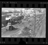 Road crew clearing landslide from Pacific Coast Highway at Sea Lion restaurant in Malibu, Calif., 1978