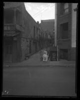 Stores off alleyway in old Chinatown in Los Angeles, Calif., 1938