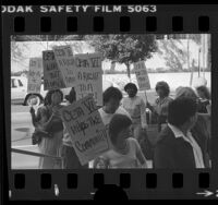 Pickets with signs in support of continuing the Comprehensive Employment and Training Act (CETA) in Los Angeles, Calif., 1981