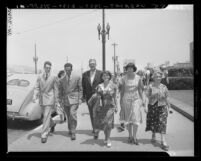 U.S. Marshal escorting Rose Chernin, Philip Connelly, Dorothy Healey and Henry Steinberg after arrest for violating the Smith Act, 1951