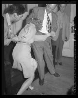 Los Angeles police officer Joe Aguirre restrains Sherry Kenton, arrested on suspicion of violating State Narcotics Act in 1947
