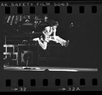 Los Angeles-based band Van Halen, guitarist Eddie Van Halen airborne during performance in Los Angeles, Calif., 1984