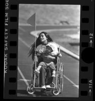 Totally Confident Disabled Drill Team member Magdalena Wodke with her son in Northridge, Calif., 1984