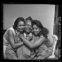 72 year-old handyman Daniel Elmore being hugged by daughters after his graduation from Jordan High School in Los Angeles, Calif., 1964