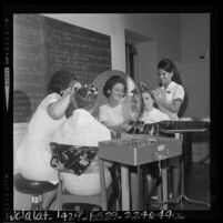 Two female students in cosmetology class at Glendale High School, Calif., 1964