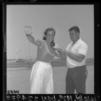Olympians Harold Connolly helping his wife Olga practice the shot-put in preparation for 1964 Olympic Games