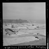 Earth-moving equipment excavating the shoreline during construction of San Onofre Nuclear Power Plant, Calif., 1964