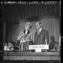Lucille Ball and Oscar Katz addressing stockholders at meeting of Desilu Productions, Calif., 1964