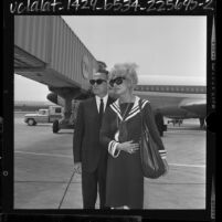 Carol Channing with husband, producer Charles F. Lowe arriving at airport in Los Angeles, Calif., 1964