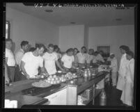 Los Angeles Rams football players going through chow line at training camp, 1947