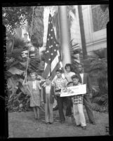 Six children, representing six different races, raising flag to open Los Angeles' Civic Unity Week, 1947