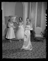 Three Junior Leaguers in evening gowns at Community Trust Fund benefit in Los Angeles, Calif., 1955