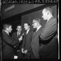 Two American Nazi Party members, Allen Vincent and attorney A. L. Wirin being interviewed by reporter in Glendale, Calif., 1965