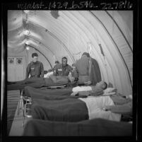 American soldiers tending to patients in medical training exercise inside inflatable hospital in Los Angeles, Calif., 1965