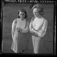 Two teenagers modeling "Boy Watcher" glasses, Calif., 1965