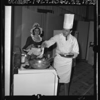 Chef Hans Prager with assistant conducting cooking demonstration in Los Angeles, Calif., 1965