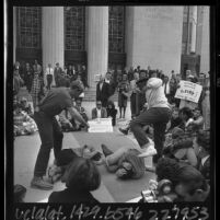 Crowd watching CORE members demonstrating non-violent protection skills on steps of Los Angeles Federal Building, 1965