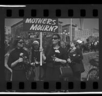 Women Strike for Peace members dressed in black carrying roses and signs during march in Los Angeles, Calif., 1965