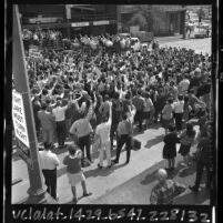 UCLA students surrounding coach John Wooden at rally for basketball team, 1965