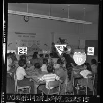 Teacher Ellen Ebers explaining meaning of traffic signs to remedial English class students in Los Angeles, Calif., 1965