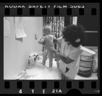 Department of Children's Services nurse examining baby at MacLaren Hall in El Monte, Calif., 1984