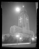 Los Angeles City Hall at night with office lights turned on in the form on a cross for Christmas, 1947