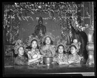 Girls in costume sit in front of Buddha during Autumn Moon Festival in Los Angeles' Chinatown, 1939