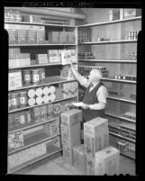 Man stocking pantry of the Ambassador Hotel in Los Angeles, Calif., 1940