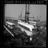 Los Angeles electric streetcars being loaded aboard the Liberian ship Santa Helena at Long Beach Harbor, Calif., 1965