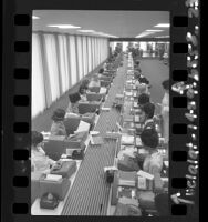 Two long rows of Credit Data Corp. operators processing credit requests in Los Angeles, Calif., 1965
