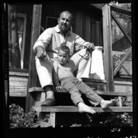 Artist Ed Kienholz and his son Noah sitting on steps of their home in Laurel Canyon, Calif., 1965