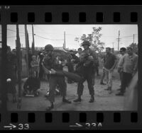 California Air National Guards removing Vietnam War protester from National Guard Base in Van Nuys, Calif., 1966