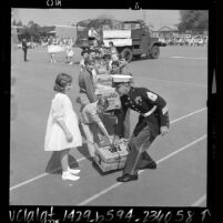 Marines and students at Vintage Elementary School loading school supplies bound for Vietnam in Los Angeles, Calif., 1967