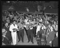 Four piece band surrounded by crowd at Mexican Independence Day on Olvera Street, Los Angeles, 1940