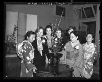 Japanese American artist Josui Oshikawa (wearing glasses) demonstrates flower arrangement at Los Angeles Junior College, 1938