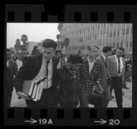 César Chávez, flanked by Jerry Cohen and LeRoy Chatfield leaving Bakersfield, Calif. courthouse, 1968