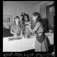 Three Girl Scouts making pie with Girl Scout cookies in Los Angeles, Calif., 1969