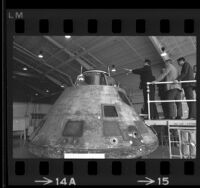 Soviet cosmonaut Georgi T. Beregovoi, astronaut Eugene A. Cernan and others inspecting Apollo 11 capsule at North American Rockwell in Downey, Calif., 1969