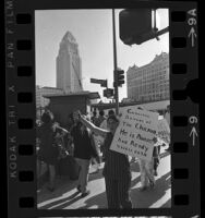 Demonstrator with sign stating "Gabachos:Beware of The Chicano He is Aware and Ready Viva La Raza" outside of Hall of Justice in Los Angeles, Calif., 1969