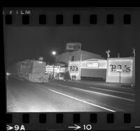 Southern Pacific freight passing theater and bar on Santa Monica Blvd., West Hollywood, Calif., 1970